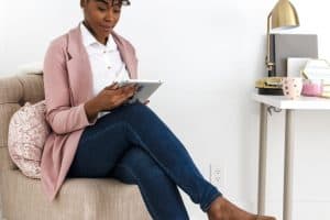 Woman working at home on her couch