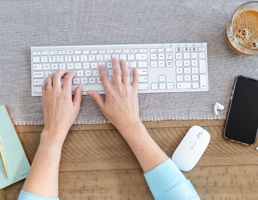 Woman's hands typing at keyboard
